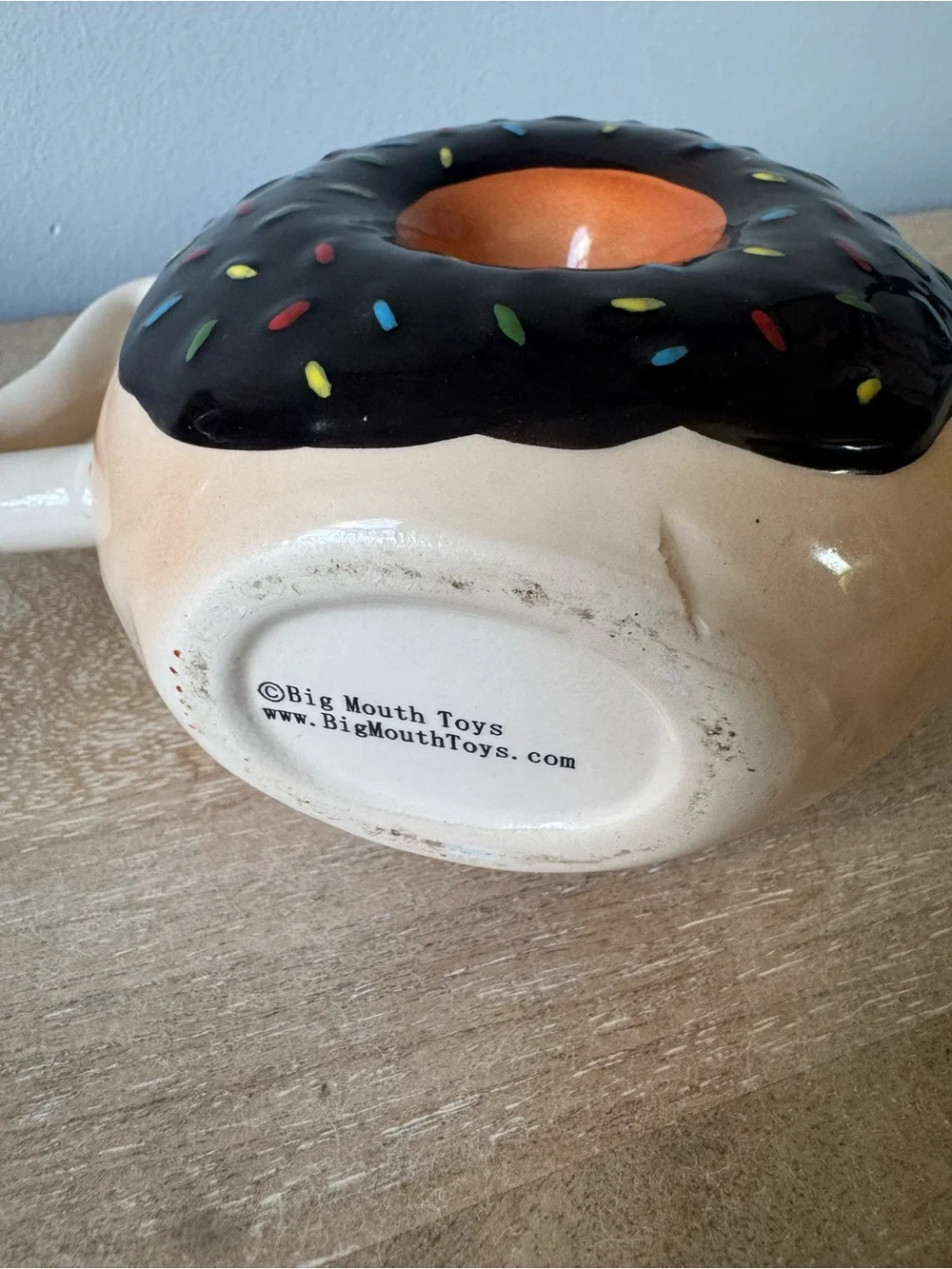 Donut-Shaped Ceramic Mug with Black Frosting and Tan Body